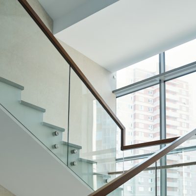 Part of staircase with railings and large window inside new business center